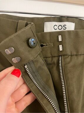 COS olive barrel leg trousers with pleating.